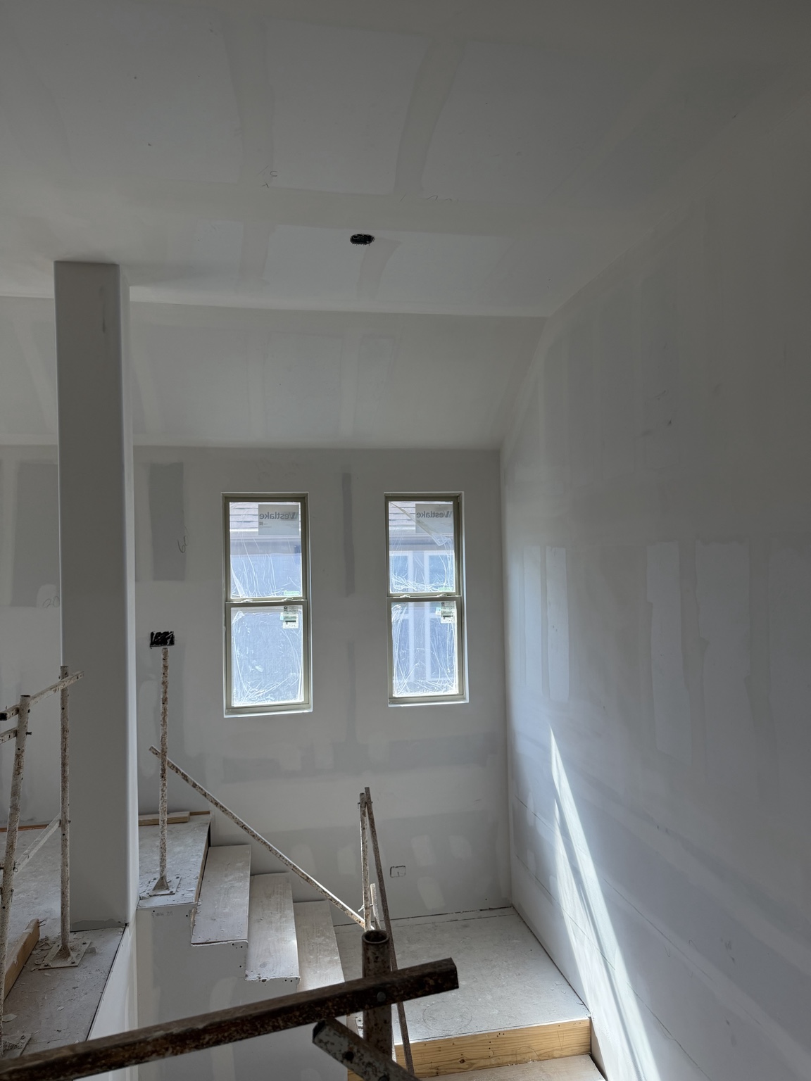 Drywall finishing around a stairwell